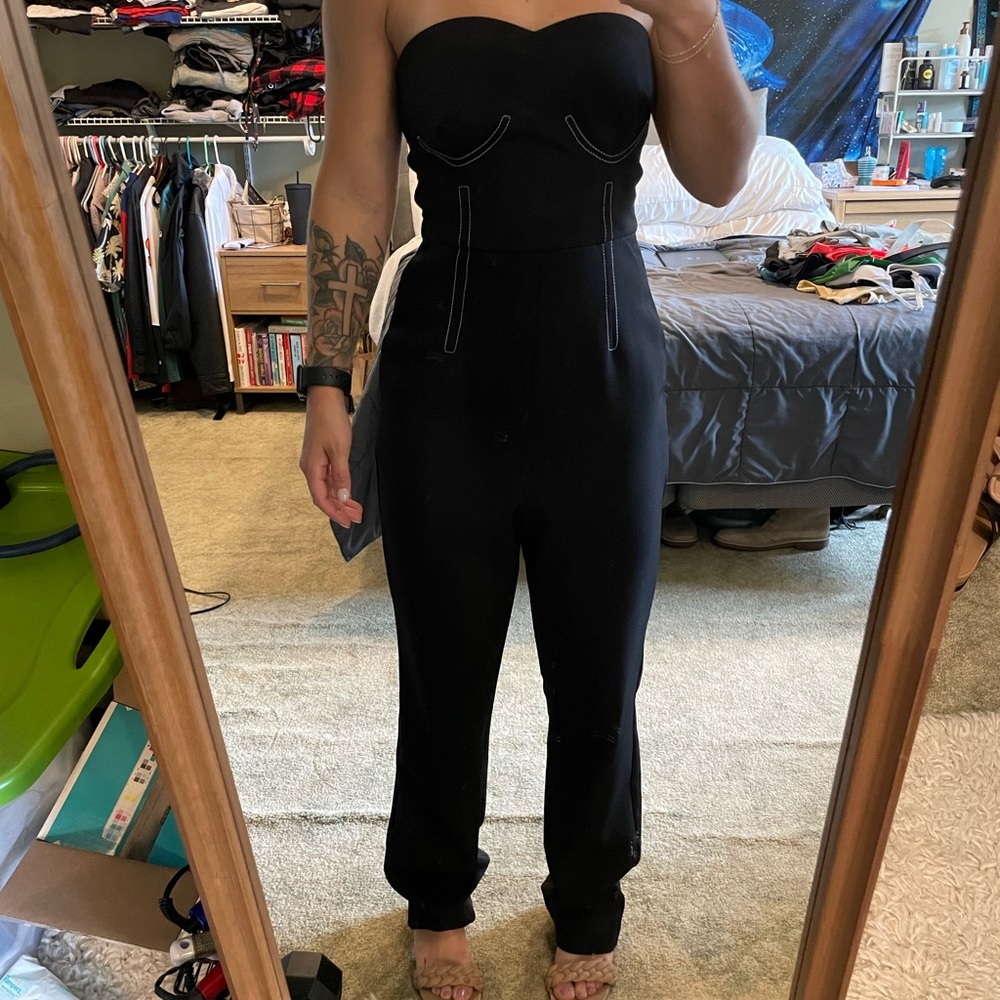 Black jumpsuit with white stitching detail